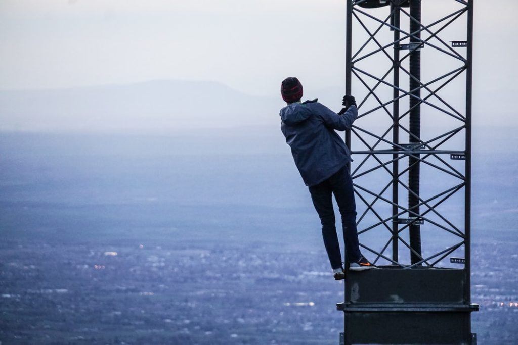 Person elevating their view by climbing a tower.